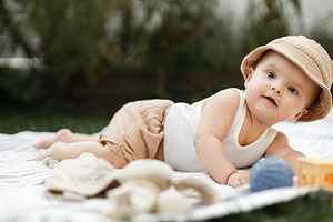 Beautiful happy baby lying on blanket with toys on background of, a Person Photo by Sonjachni