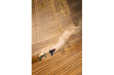 Aerial View. Tractor Plowing Field, an Industrial Photo by Our Amazing World
