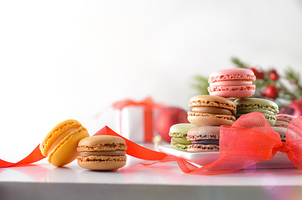 Macaroons of various flavors with red bow and gift isolated, a Food & Drink Photo by Davizro's Market