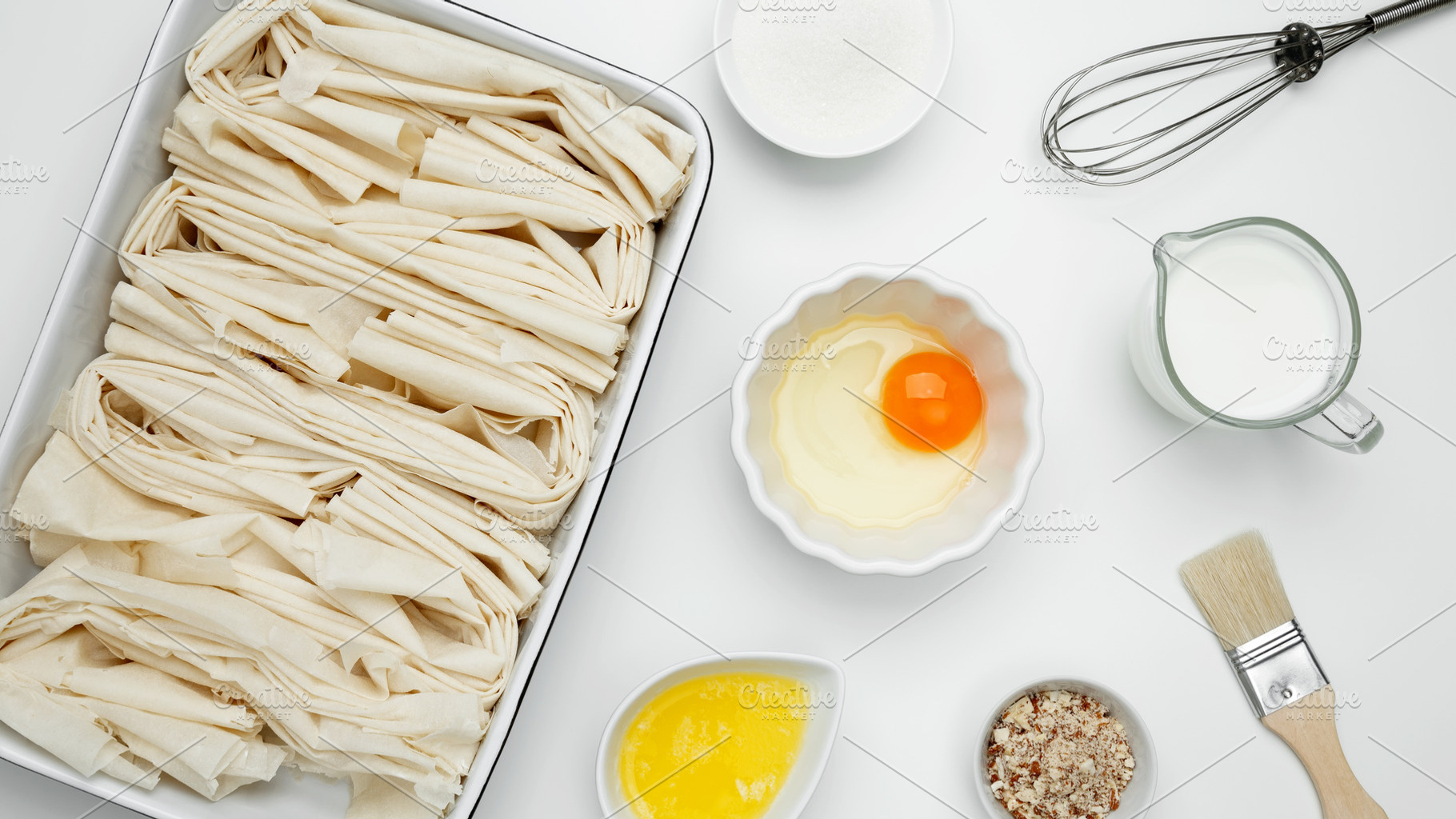 Crinkle Cake baking, filo dough in a baking dish near milk, eggs, butter, butte, a Photo by matucha