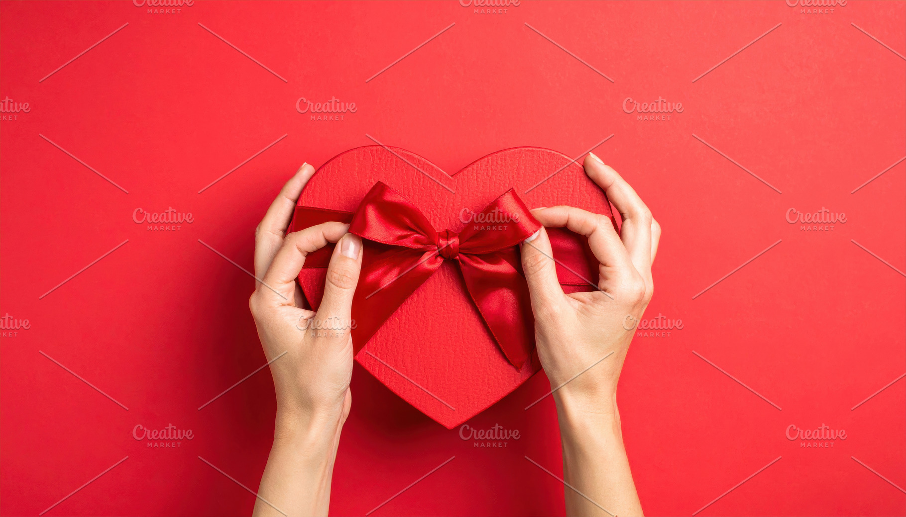 Hands Holding Heart Shaped Gift Box, a Holiday Photo by Davizro's Market