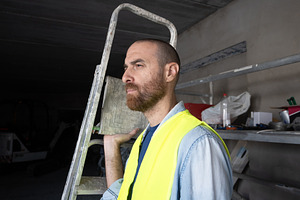 Construction worker carrying a ladder inside a workshop, a Person Photo by etorres69