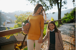 Mother and daughter going home after, a School & Education Photo by HalfPoint