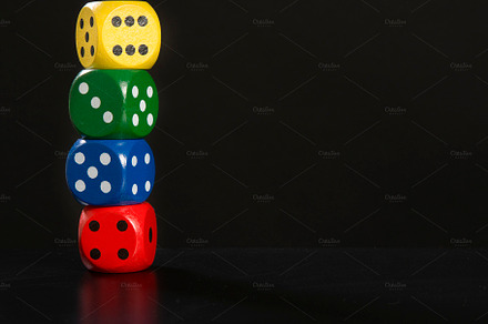 Colorful gaming dices stacked on a b