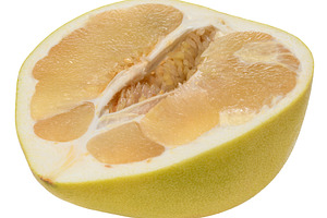 Half of juicy ripe pomelo on isolated background, a Food & Drink Photo by ndanko