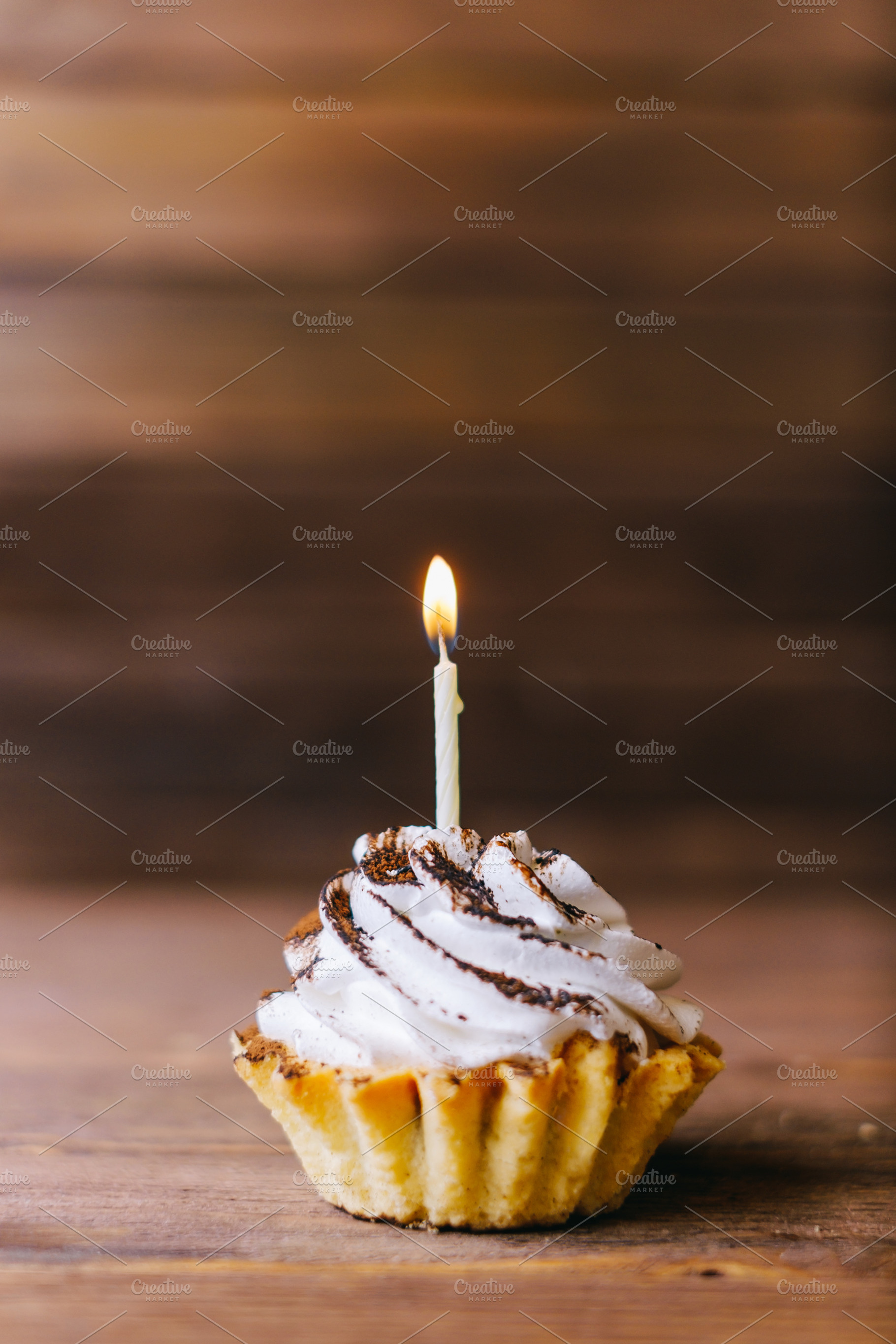 Cream cupcake with one candle., a Food & Drink Photo by P&G