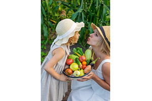 A child with a vegetable harvest in, a Nature Photo by yanadjana