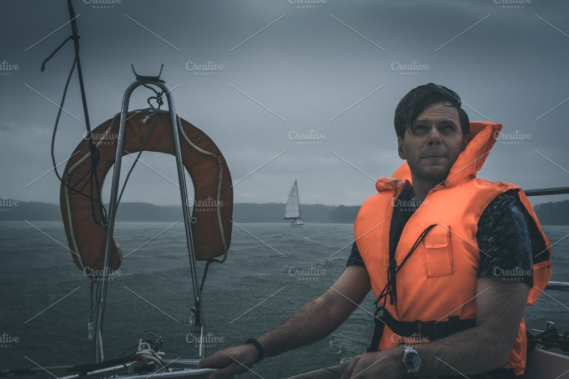 Male sailing under heavy rain, a Sports & Recreation Photo by supamotion