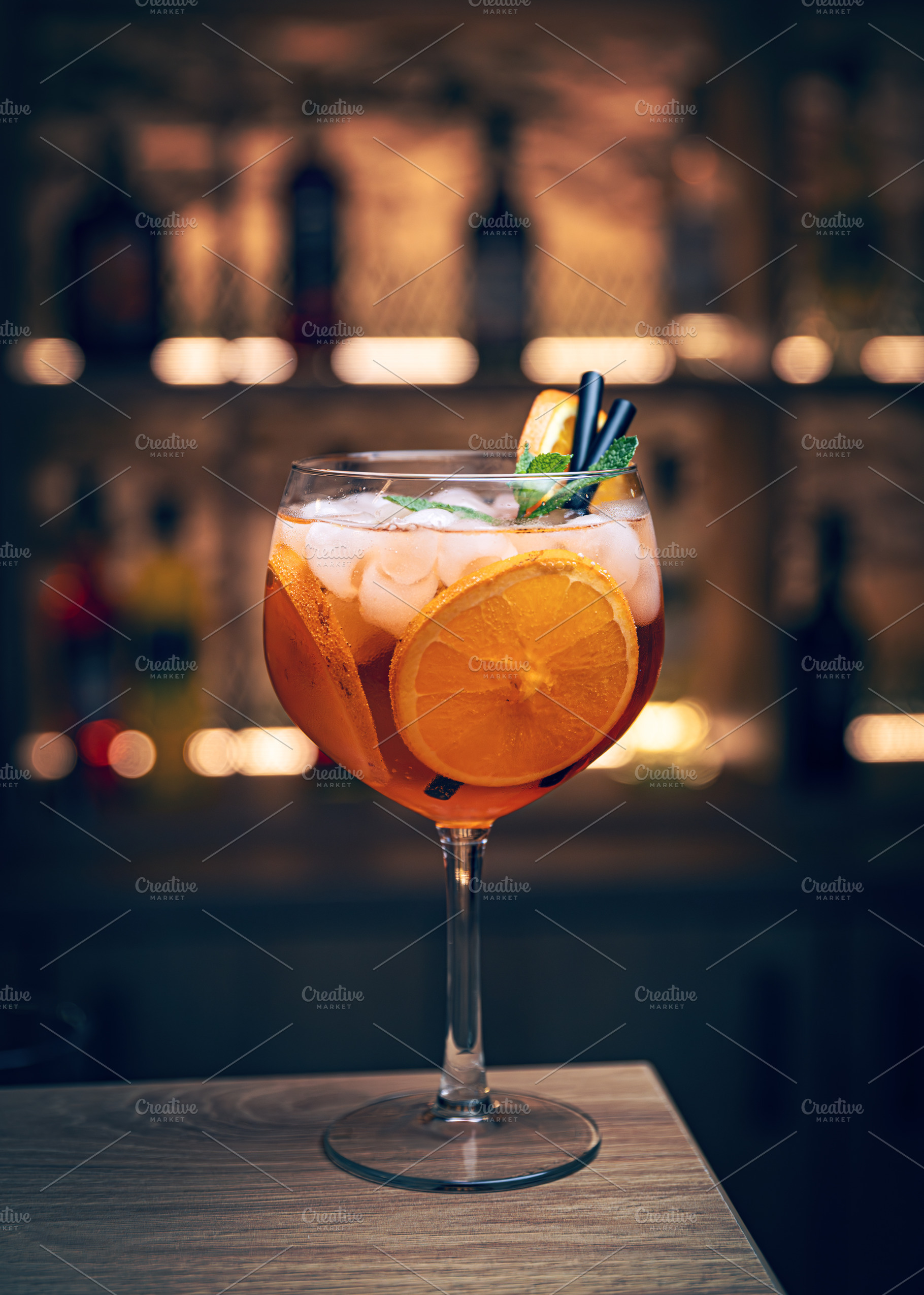 Orange cocktail with ice and mint, a Photo by Grafvision photography