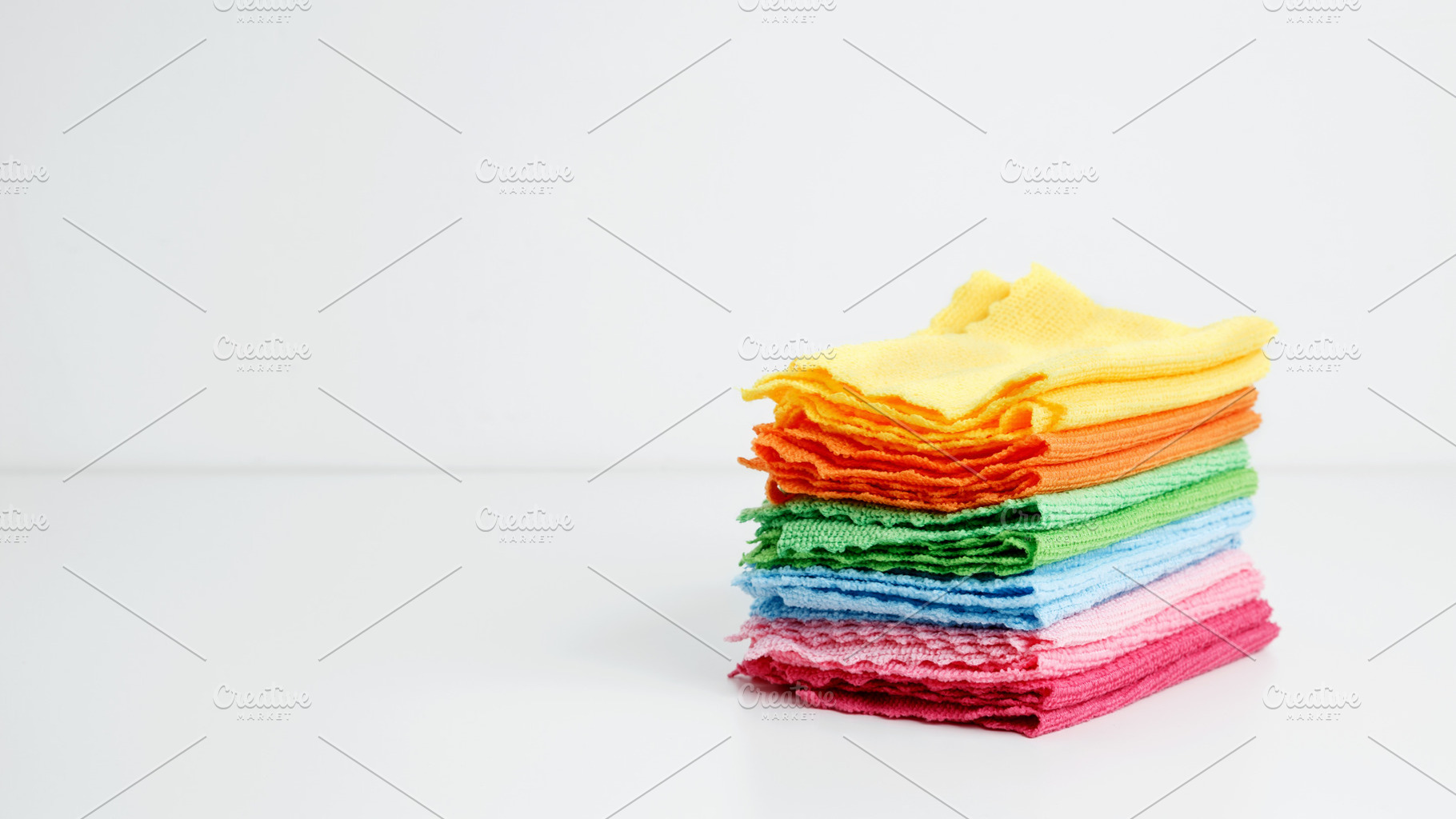 Household cleaning and hygiene concept. Colorful cleaning cloths neatly arrange, a Photo by matucha