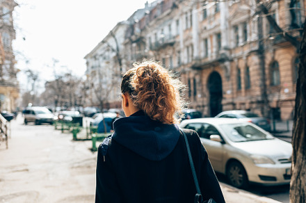 Rear view young woman in black coat, a Person Photo by progressman