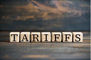 Word TARIFFS on wooden blocks over, a Business Photo by Gladkov photography