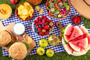 Tasty summer barbecue table with hamburgers, salads, fruits and, a Food & Drink Photo by Rimma