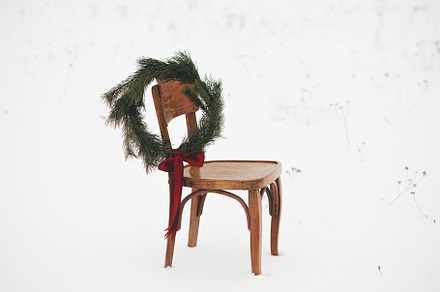 Christmas wreath on chair in snowy winter field. Merry Christmas, a Holiday Photo by Sonjachni