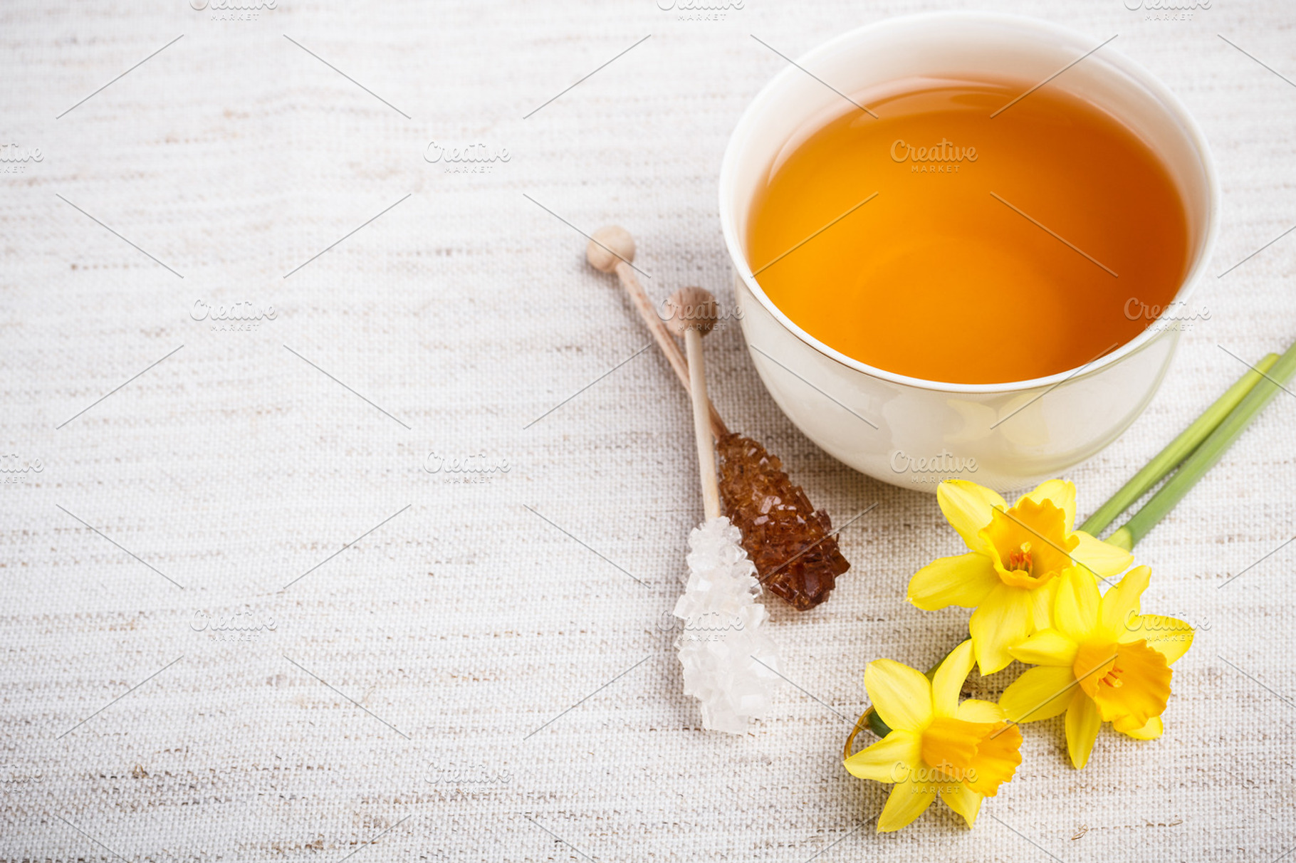 Cup of black tea containing tea, flower, and cup