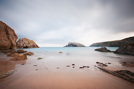 Long exposure photography on a beach containing beach, sea, and stone