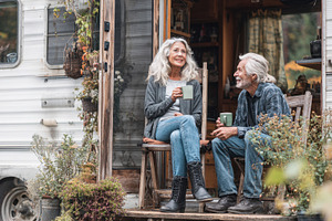 Couple enjoys drinks on camper porch, a Photo by Beautiful things