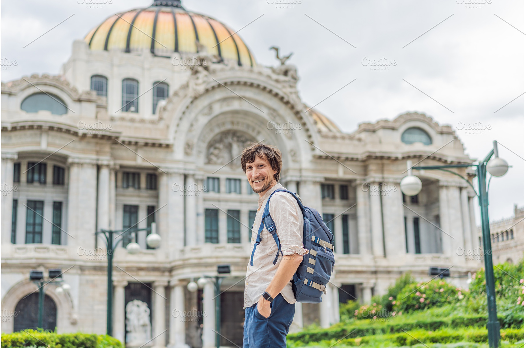 Male tourist standing in front of, an Architecture Photo by Elizaveta Galitskaya