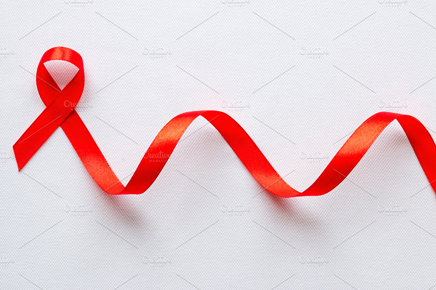 red ribbon symbol of World AIDS Day, a Health & Medical Photo by itakdalee