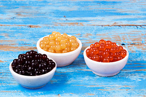 Blueberry passion fruit bobas containing bubble tea, tapioca pearls, and drink
