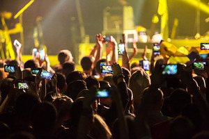 Crowd at concert and blurred stage lights  featuring crowd, people, and event