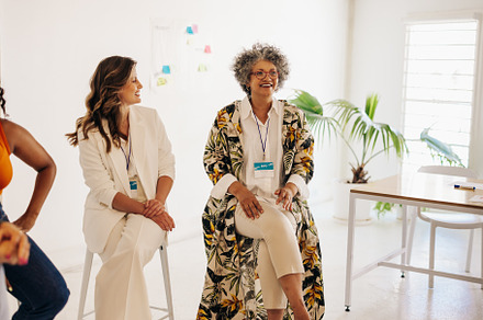 Cheerful businesswomen having a conference meeting in an office