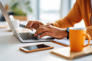 Hands typing on a sleek laptop in a cozy workspace during a productive afternoo, a Business Photo by AlyaAnd