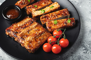 Closeup of pork ribs grilled with BBQ sauce and caramelized in honey., a Food & Drink Photo by Budarinphoto
