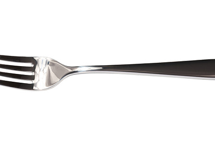 New stainless steel fork on a white isolated background, a Food & Drink Photo by ndanko
