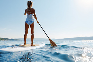 Young woman in a swimsuit enjoys sup, a Sports & Recreation Photo by MistyDay