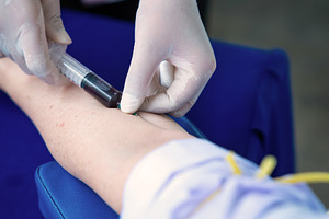 Close up hand collecting blood sample for diagnosis and treatmen, a Health & Medical Photo by Casanowe-studio