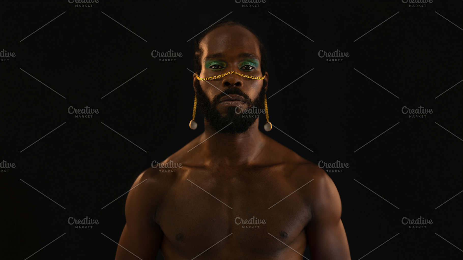 Serious African American shirtless gay model with makeup over black background, a Person Photo by andreonegin market