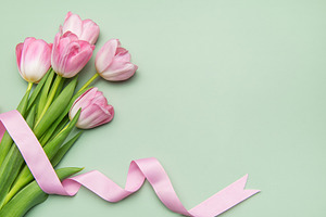 Pink tulips with ribbon on pastel green background for spring ho, a Nature Photo by Olena Rudo