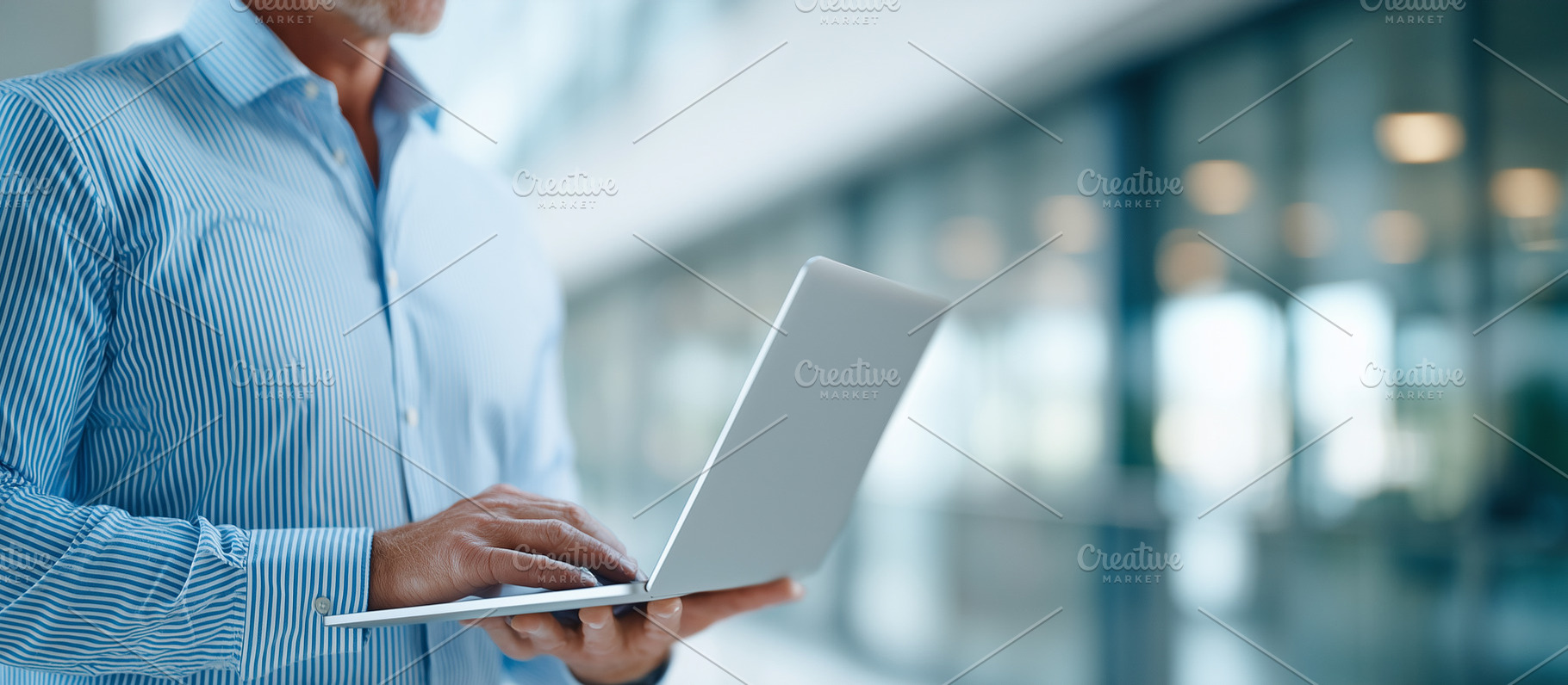 Man in a blue striped shirt standing, a Business Photo by MistyDay