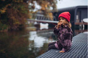 Cute toddler girl sitting in harbor, a Beauty & Fashion Photo by HalfPoint