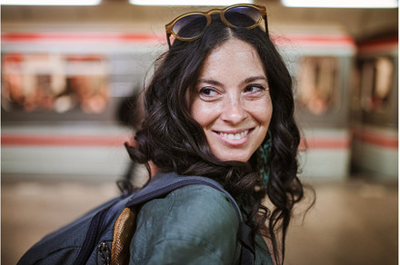 Mid adult woman commuter is standing, a Person Photo by HalfPoint