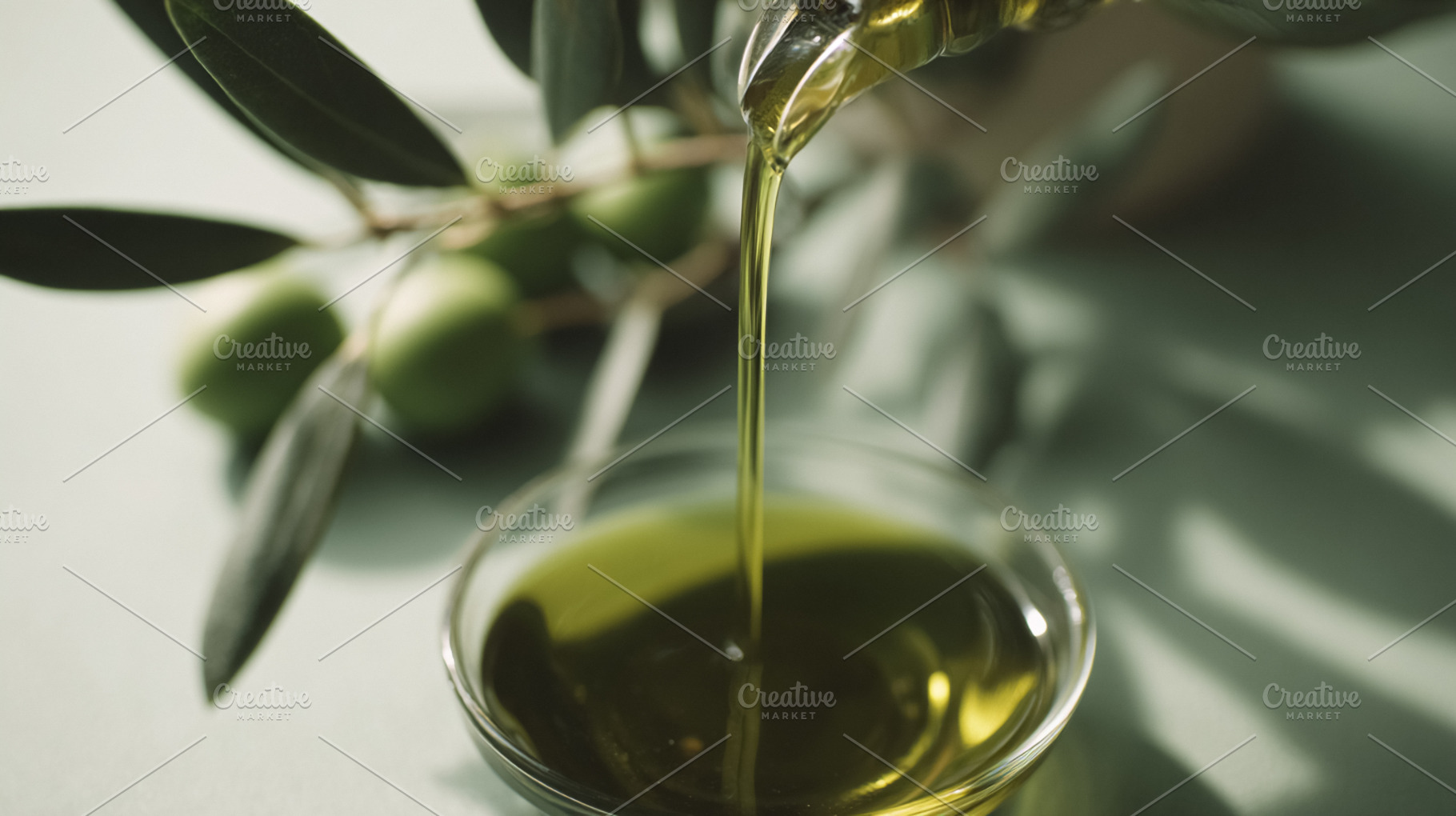 Pouring fresh extra virgin olive oil into a bowl, showcasing hea, a Photo by Studio ANNA