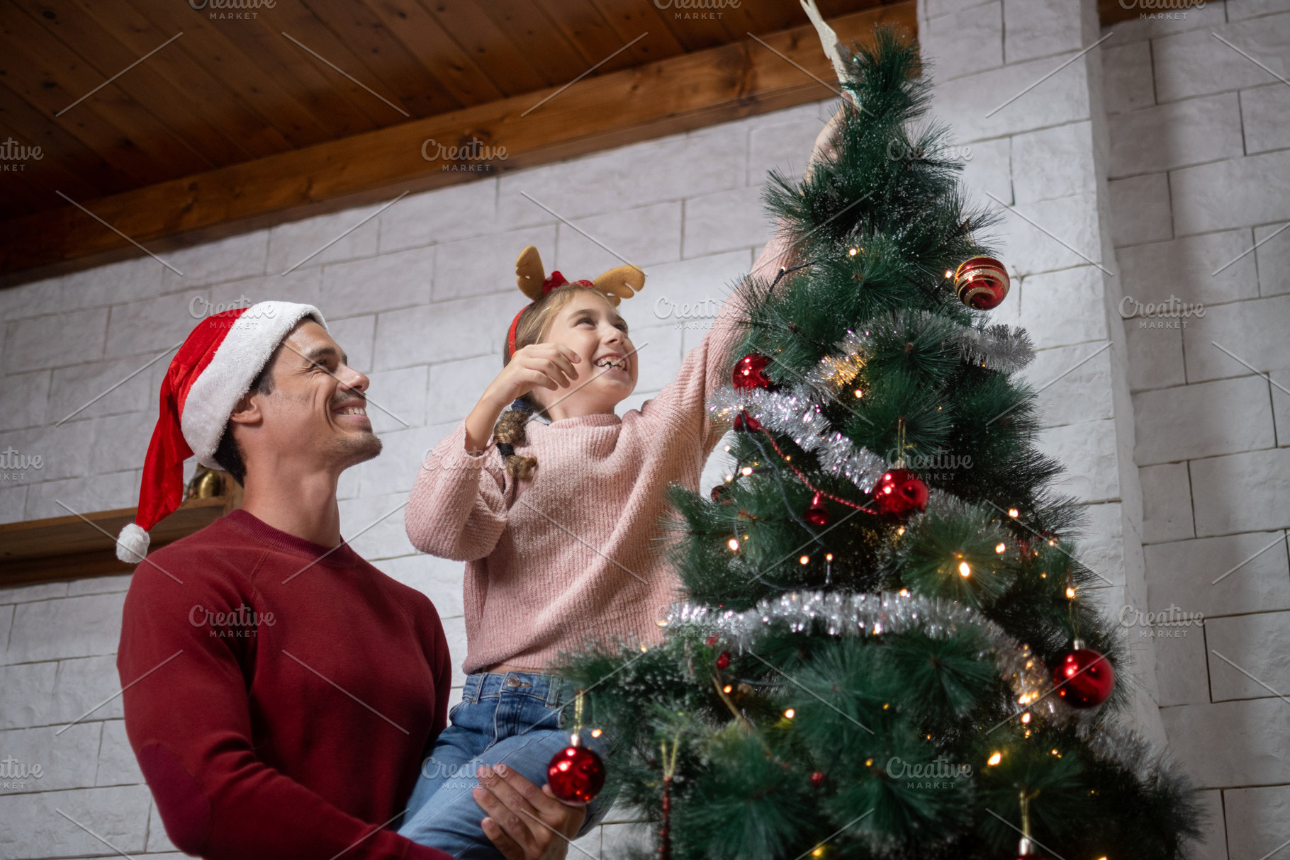 Father and daughter decorating Christmas tree together, a Holiday Photo by etorres69