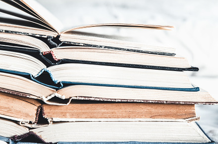 Opened books in a stack featuring grunge, retro, and vintage