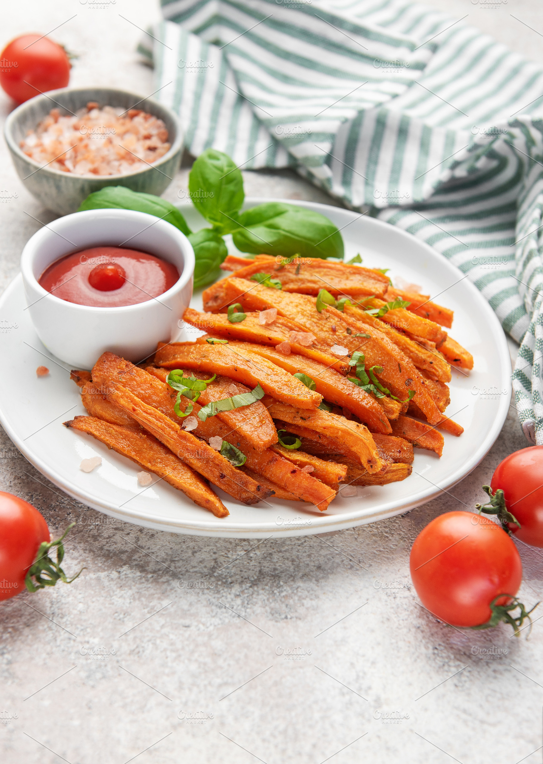 Sweet potato fries with ketchup and basil leaf, a Food & Drink Photo by Olena Rudo