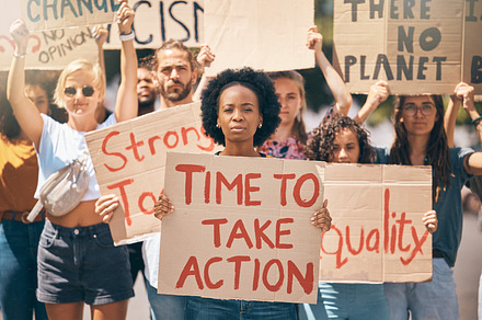 Group, protest and portrait in street, poster or climate change with march, walking or together for change. People, diversity or action in activism, equality or empowerment for racism, lgbt and earth, a Photo by Peopleimages.com