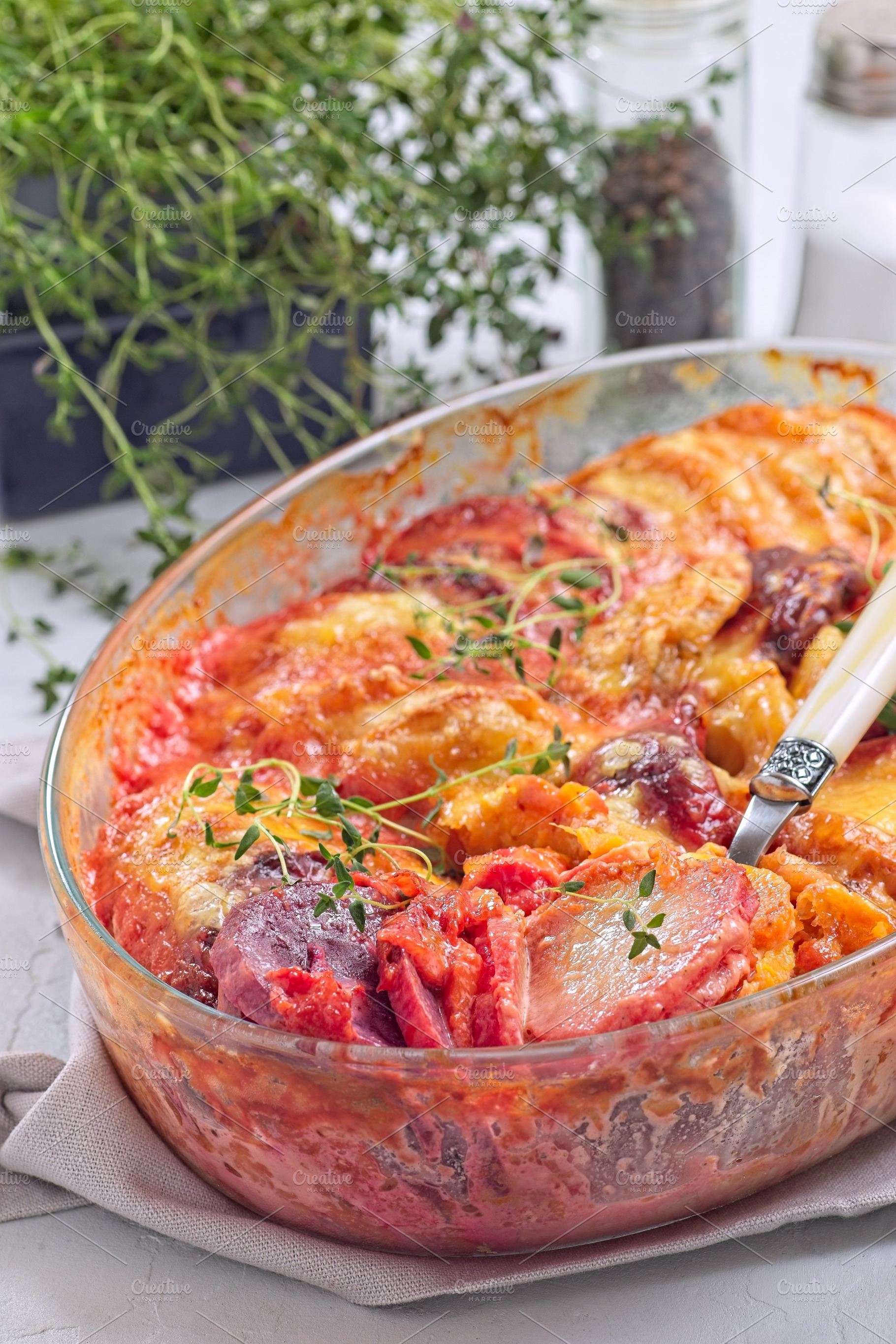 Sweet potato, parsnips and beet root au gratin with thyme and melted cheese, in, a Food & Drink Photo by iuliia_n