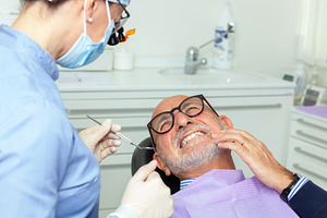 Senior man feeling toothache during dental examination, a Health & Medical Photo by Antonio Gravante Market