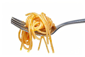 Spaghetti rolled on a fork on white background, a Food & Drink Photo by AlyaAnd