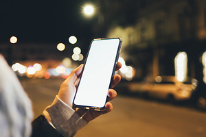 Close-up smartphone with blank display in female hand