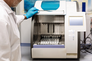 Scientist operating an automated sam, a Health & Medical Photo by Perpis