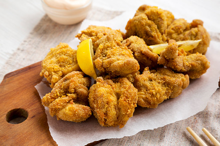 Homemade traditional japanese fried chicken Karaage on a rustic, a Food & Drink Photo by LiudmylaChuhunova