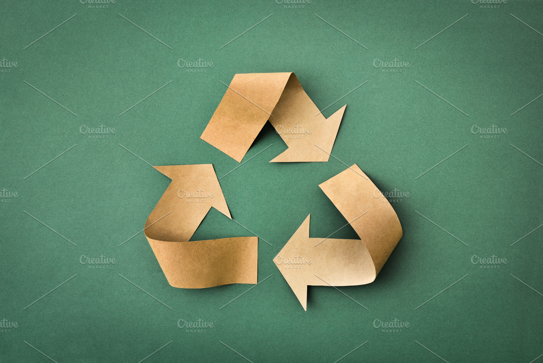 Recycling symbol made of brown paper on green textured backgroun, a Nature Photo by Davizro's Market