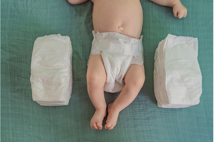 Baby lying between two stacks of