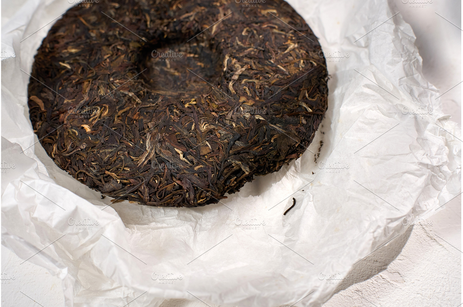Puer tea cake displayed on white, a Background Photo by darksoul72